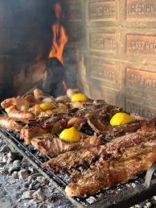 Savory Argentine asado with meat and lemon slices grilling on an open fire in Mendoza.